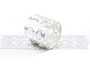Detailed silver laser-cut paper napkin ring with hollow floral pattern and mirror finish