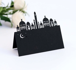 Detail of black laser cut mosque place card with moon and stars for banquet tables