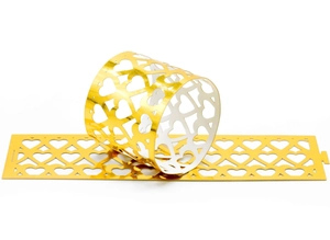 Detail showing laser-cut gold hollow heart pattern on decorative napkin rings