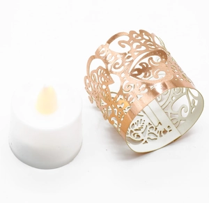 Macro view of rose gold laser-cut paper lantern with heart patterns and LED candle