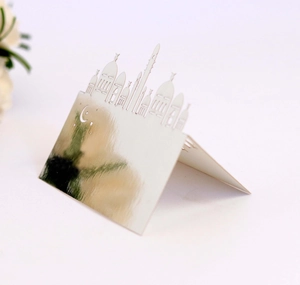 Detail of laser-cut mosque silhouette on a pearlized white foldable wedding table card