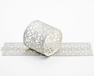 Detailed view of silver glitter napkin rings with intricate laser-cut lace patterns