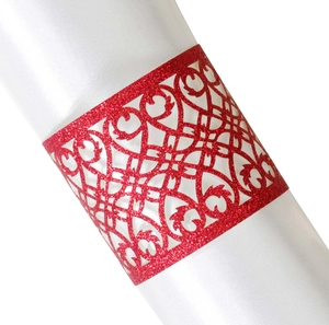 Macro view of red glitter laser cut napkin ring with elegant floral pattern on white silk