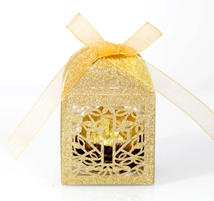Detailed laser-cut hollow cross gift box in gold glitter finish with organza ribbon