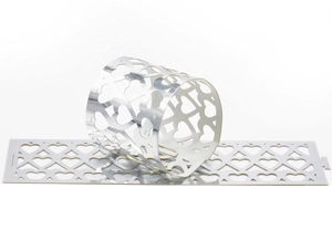 Close-up of laser-cut silver heart napkins ring with reflective mirror surface finish