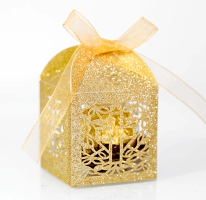Detailed view of golden glitter cross hollow candy box with a light gold ribbon bow
