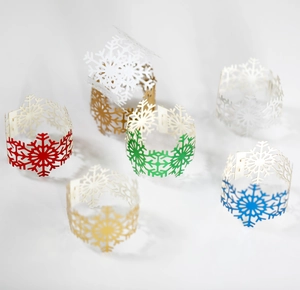 Detailed laser-cut snowflake napkin rings in festive colors for Christmas table decor