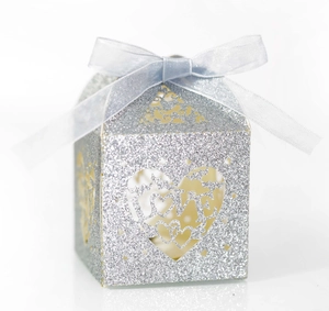 Detail of silver glitter wedding favor box with LOVE hollow heart and blue silk ribbon