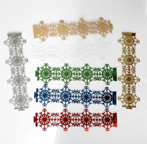 Close-up of snowflake napkin rings in various metallic colors for Christmas table decor