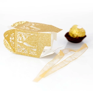 Detail showing the laser-cut hollow pattern and glitter texture of the gold wedding favor box