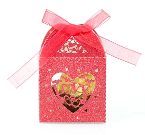 Close-up of red glitter love gift box with laser-cut heart and ribbon detail