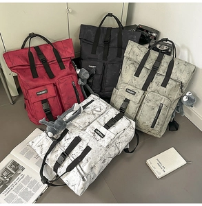 Detailed view of four colorful backpacks with marble texture and plush doll accessories