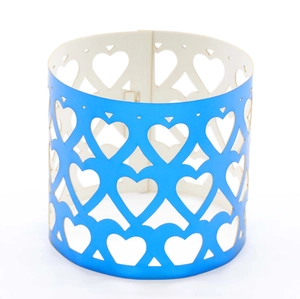 Macro shot of royal blue hollow heart laser-cut paper napkin ring for elegant table decor