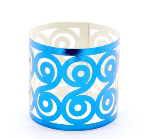 Macro shot of laser-cut metallic blue napkin rings with elegant hollow scroll patterns