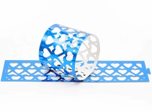 Blue heart laser-cut napkin ring detail with intricate hollow pattern and metallic finish