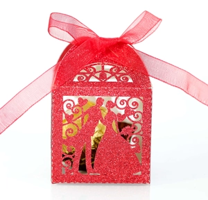 Detail of red glitter hollow wedding candy box with groom and bride silhouette