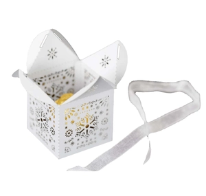 White laser-cut snowflake candy box with a golden chocolate and white silk ribbon