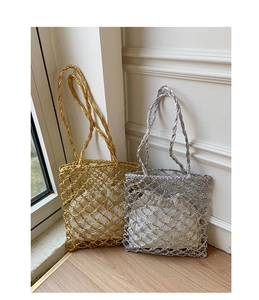 Close-up of metallic woven tote bags with drawstring liners and knotted handles