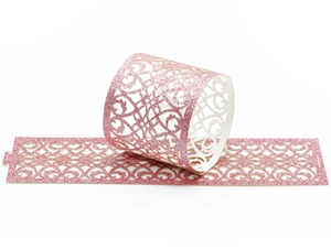 Detail of pink glitter hollow paper napkin ring with heart pattern laser cut design