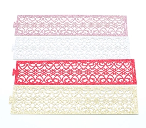 Close-up of laser-cut glitter napkin rings with heart patterns in four colors