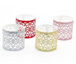 Detailed view of hollow heart glitter paper napkin rings in silver, red, gold, and pink