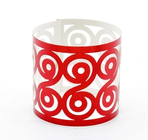 Detail of red laser-cut cupcake wrappers with elegant spiral hollow patterns