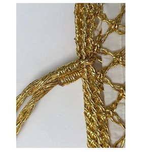 Close-up of golden woven handbag detail with manual knots and premium cotton lining