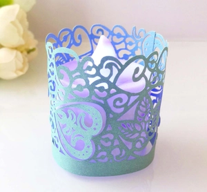 Detail of laser-cut heart leaf paper candle shade with purple LED light and glitter finish