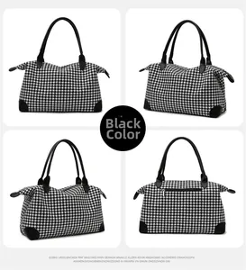 Détails du sac de voyage pied-de-poule noir et blanc avec finitions en cuir et fermetures