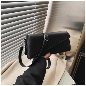 Detail of black leather crossbody bag with geometric stitching and silver metal buckle