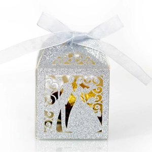 Silver glitter laser-cut wedding favor box with bride and groom silhouette and ribbon