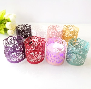 Detail of laser-cut paper decorative sleeves with flower patterns for LED tea lights