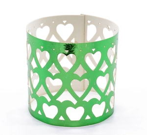 Detail of green metallic hollow heart pattern napkin rings for elegant table decor