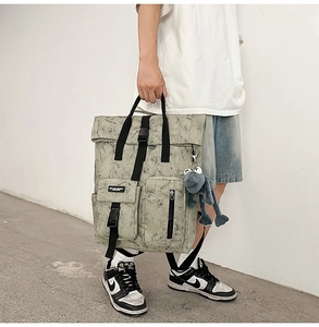 Detail of grey marble pattern backpack featuring multiple pockets and buckle straps