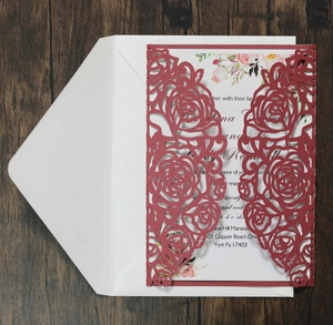 Detail of laser-cut burgundy rose wedding invitation set with floral inner card