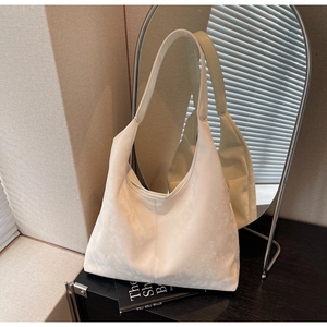 Detail of white large capacity hobo bag featuring marble print and soft leather texture
