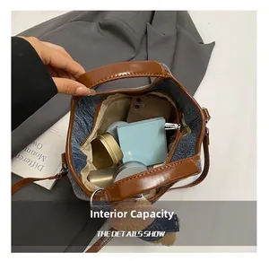 Detail showing the large interior capacity of this denim bucket bag with daily essentials