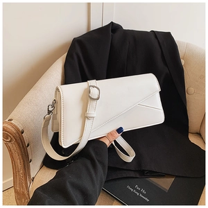 Minimalist white leather crossbody bag with diagonal flap and silver buckle detail