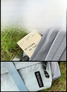 Detail of color-block nylon backpack featuring smile embroidery and hidden back pocket