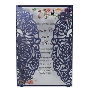 Detail of laser-cut rose hollow pattern on navy blue wedding invitation cards