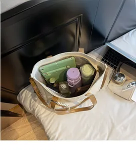 Spacious interior of a beige woven tote bag holding a tablet and daily essentials