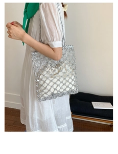 Silver woven mesh tote bag with a white drawstring liner shown on a female model