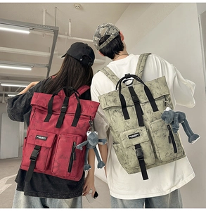 Detail of large utility backpacks with cloud texture and monkey keychain accessories