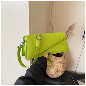 Detail of neon green leather crossbody bag with unique geometric asymmetric folding flap