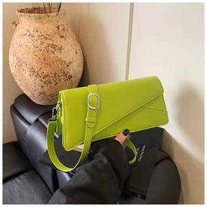 Detail of lime green leather crossbody bag with asymmetric geometric flap design