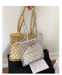 Detail of metallic hollow mesh tote bag with inner drawstring pouch and twisted handle
