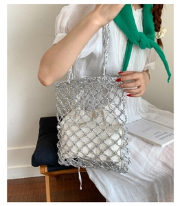 Silver metallic woven tote bag with a cream canvas drawstring pouch insert on model