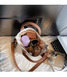 Detail view of the spacious interior of a canvas tote bag with daily items