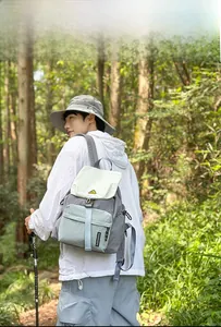 Outdoor view of a lightweight colorblock backpack featuring a yellow smiley patch