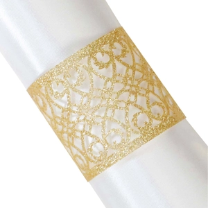 Elegant gold glitter napkin ring with laser-cut vine design on white satin fabric